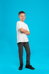 Photo of Full length portrait of preteen boy on light blue background