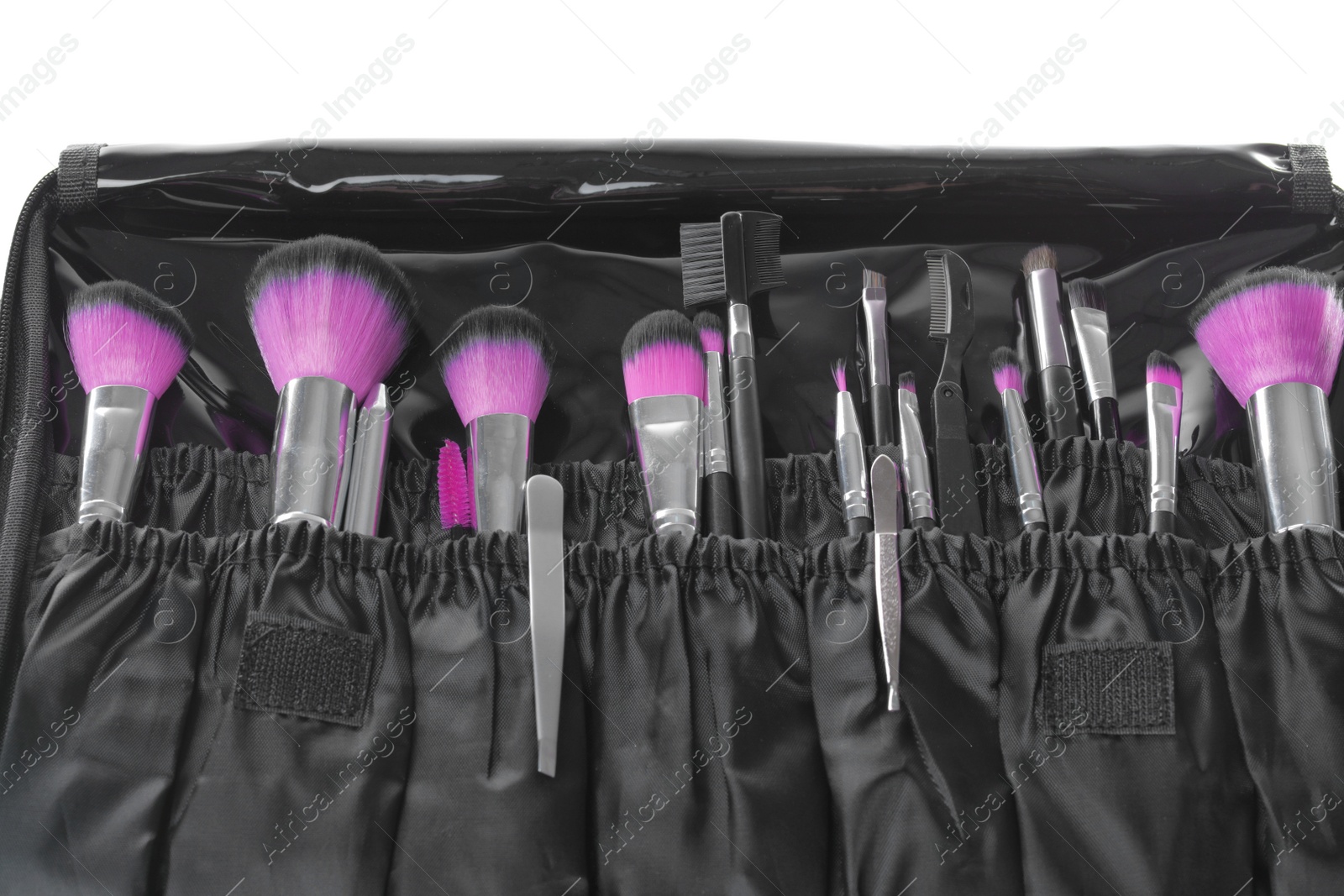 Photo of Stylish case with tweezers and brushes for applying makeup products on white background, closeup