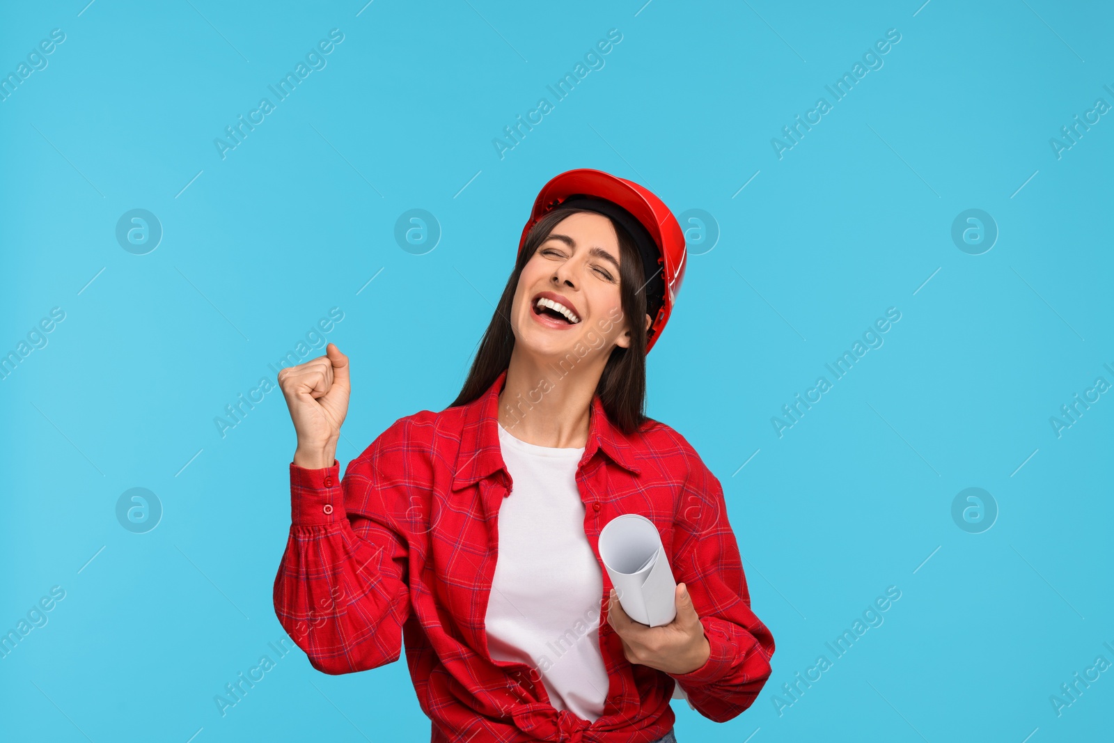 Photo of Architect in hard hat with draft on light blue background