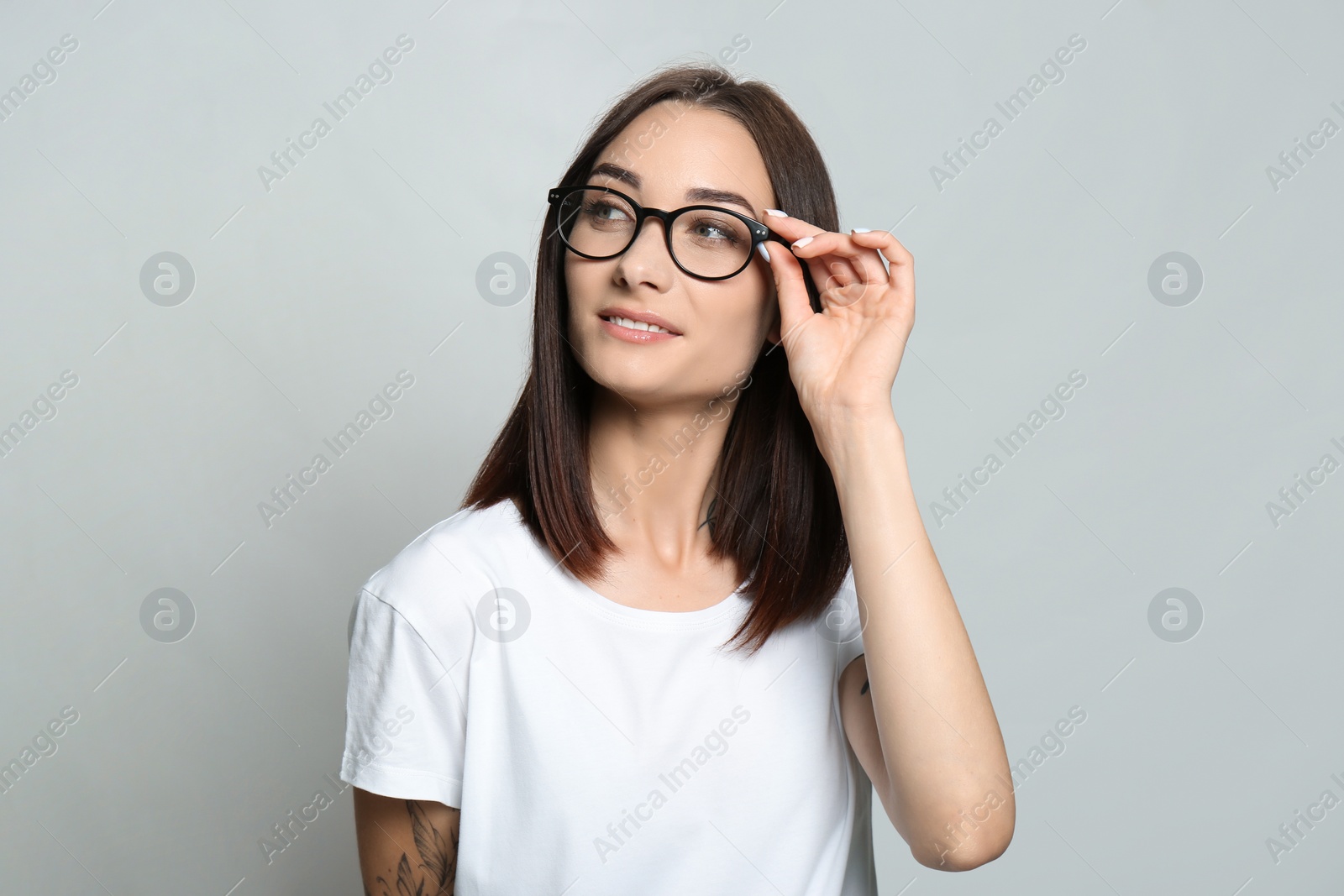 Photo of Portrait of pretty young woman with gorgeous chestnut hair on light background