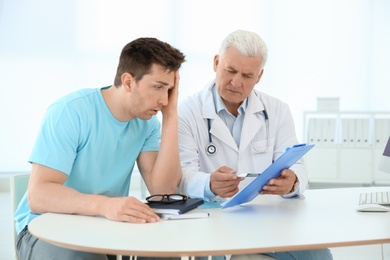 Man with health problems visiting urologist at hospital