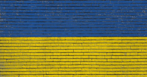 Image of National flag of Ukraine painted on brick wall, banner design