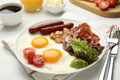 Photo of Delicious breakfast with sunny side up eggs served on white table, closeup