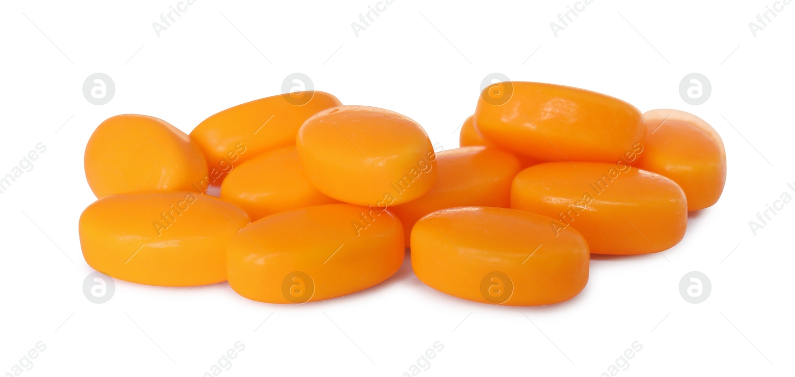 Photo of Tasty orange dragee candies on white background