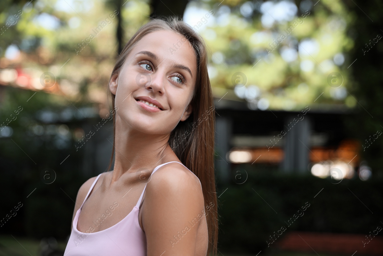 Photo of Portrait of beautiful young woman in park, space for text