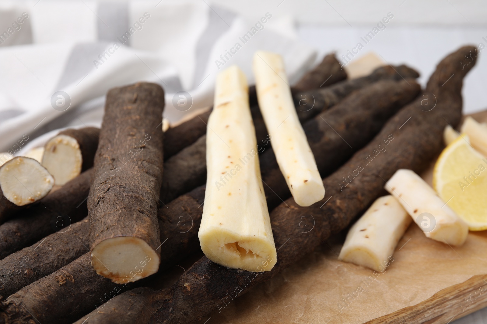 Photo of Fresh raw salsify roots on table, closeup