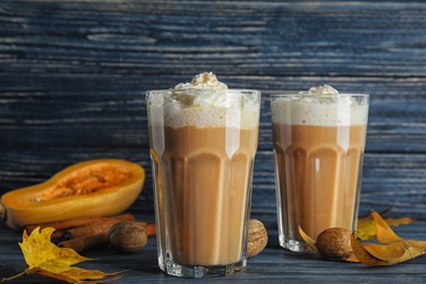 Photo of Composition with tasty pumpkin spice latte on table