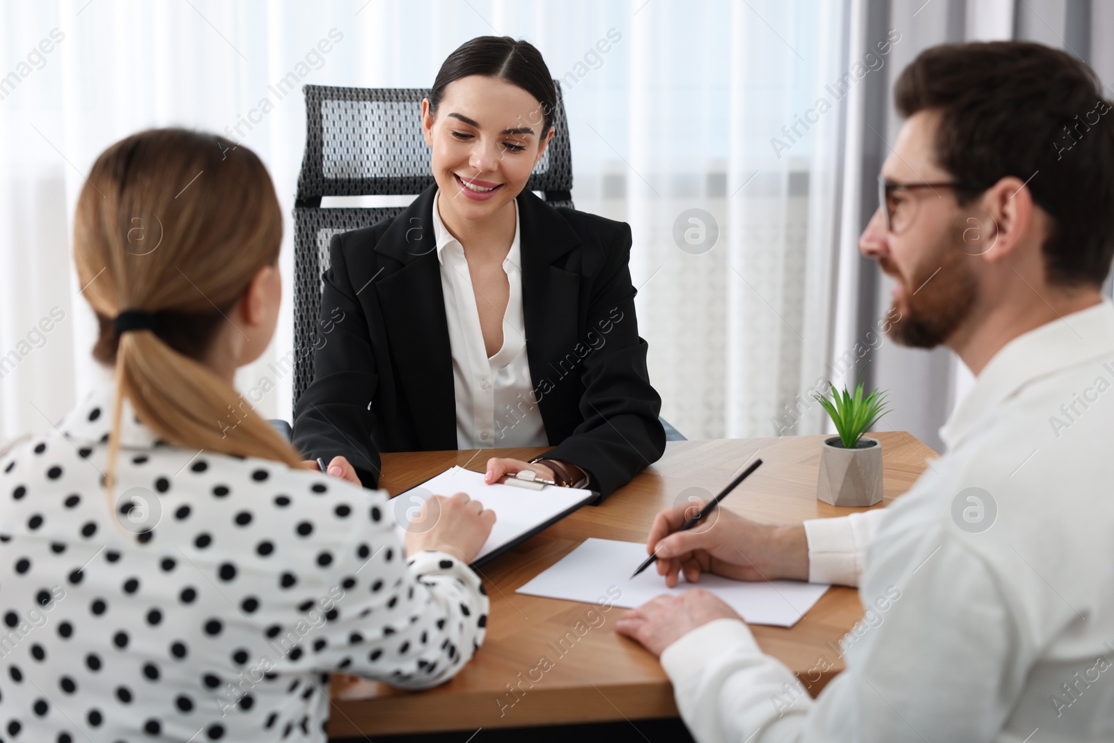 Photo of Couple having meeting with lawyer in office