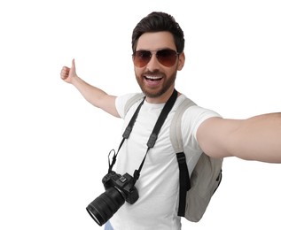 Photo of Smiling man with camera taking selfie and showing thumbs up on white background