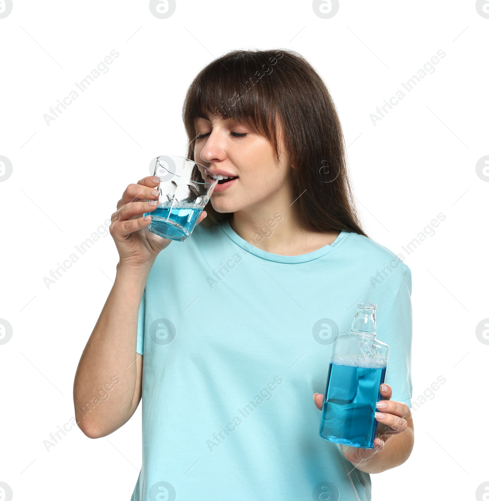 Photo of Young woman using mouthwash on white background