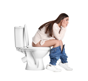 Photo of Upset woman sitting on toilet bowl, white background