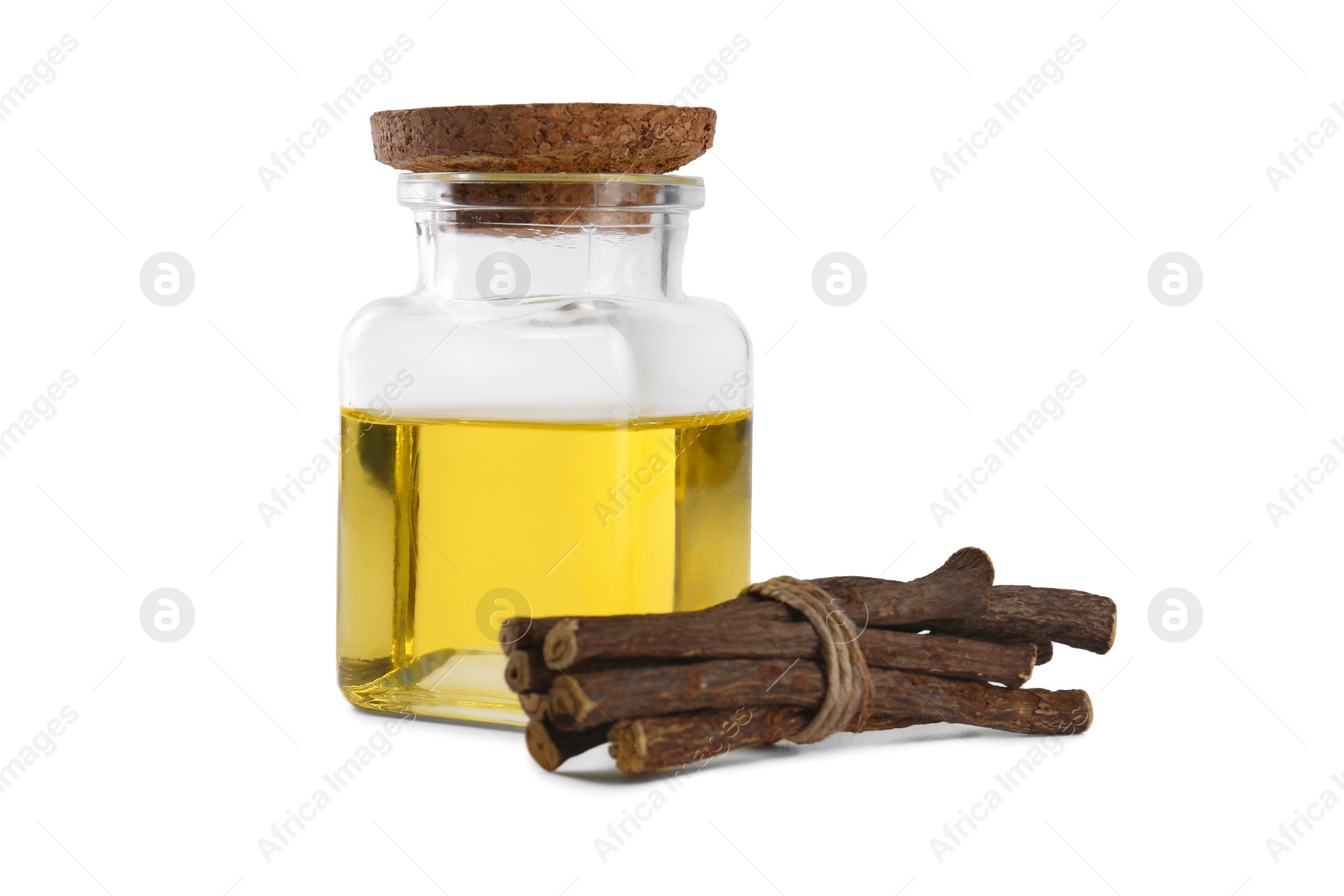 Photo of Dried sticks of licorice root and essential oil isolated on white