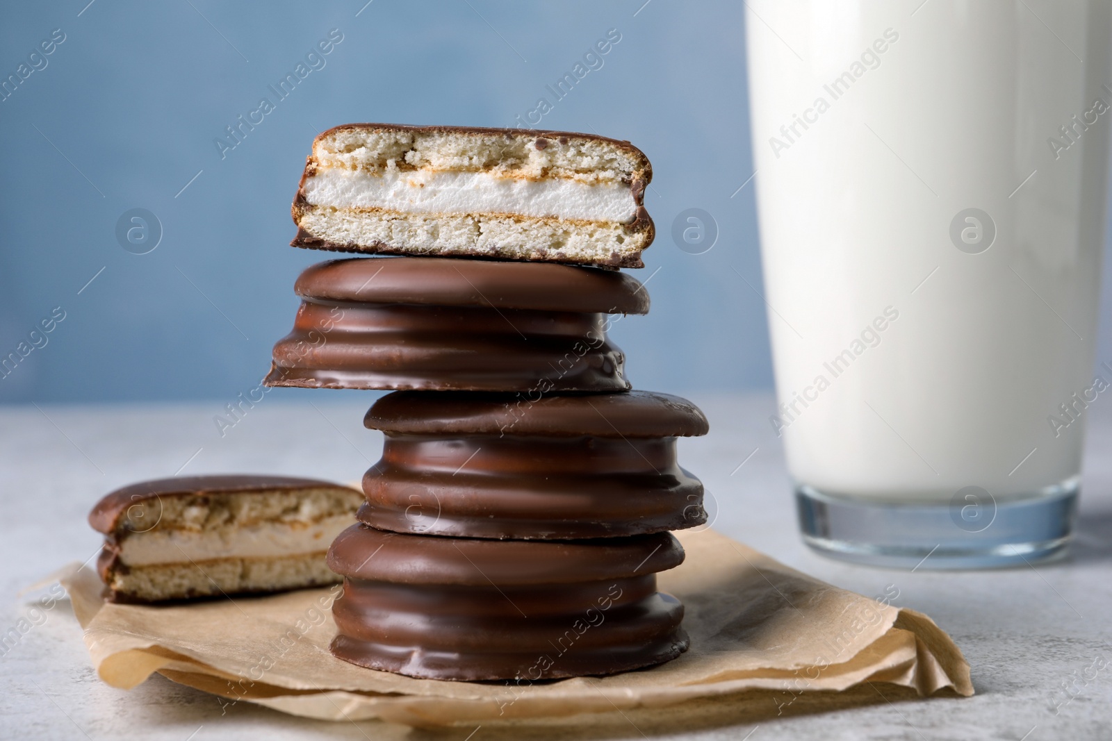 Photo of Tasty choco pies and milk on grey table