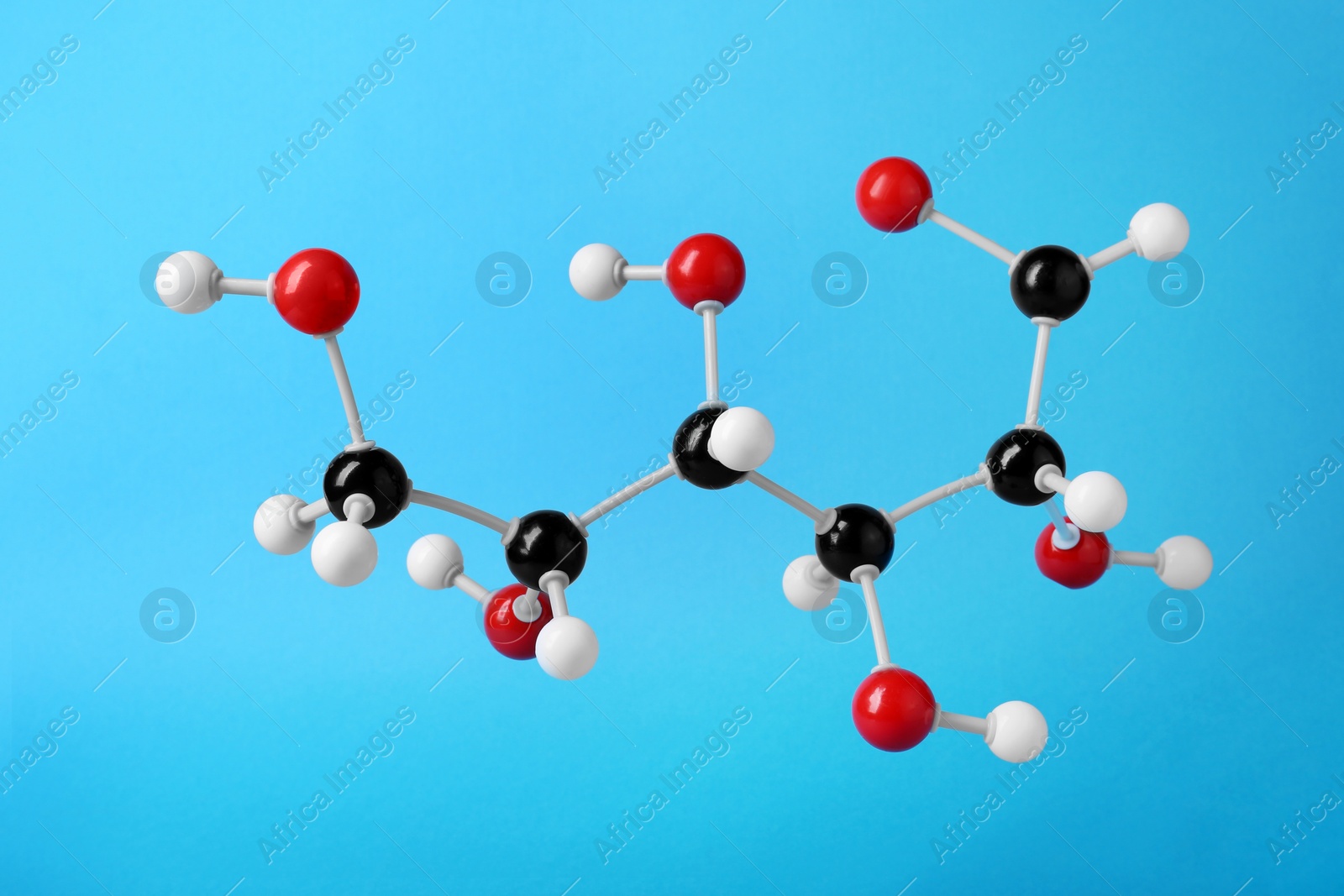 Photo of Molecule of glucose on light blue background. Chemical model
