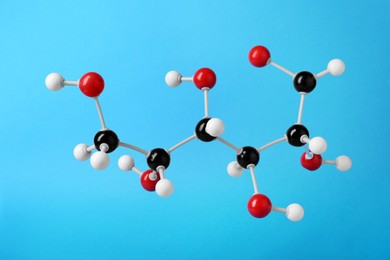 Photo of Molecule of glucose on light blue background. Chemical model