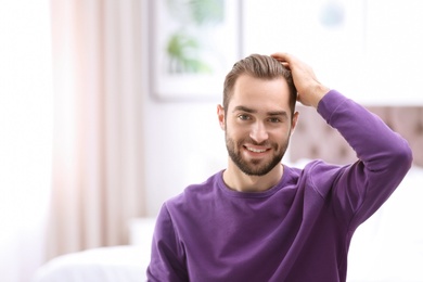 Photo of Portrait of young man with beautiful hair indoors