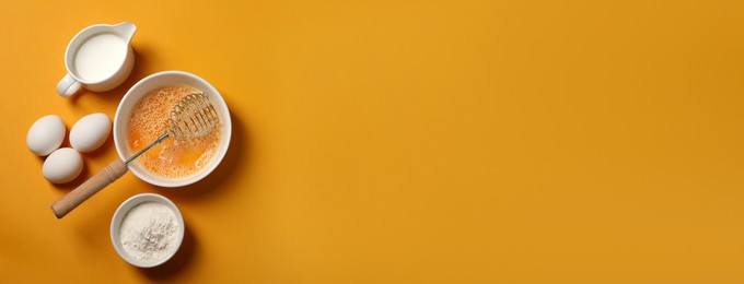 Image of Metal whisk, beaten eggs, flour and milk on orange background, flat lay. Banner design with space for text