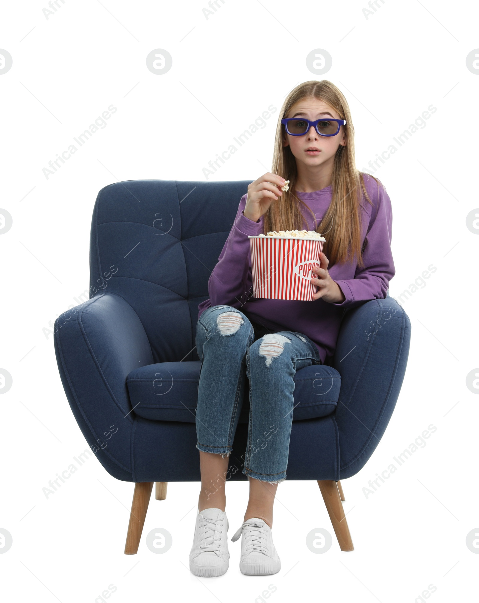 Photo of Emotional teenage girl with 3D glasses and popcorn sitting in armchair during cinema show on white background