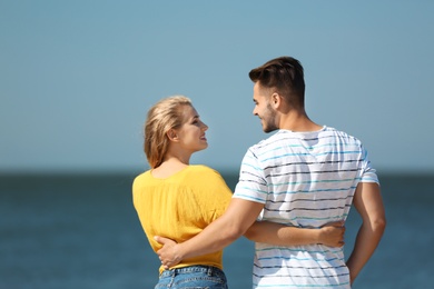 Photo of Happy young couple at beach on sunny day