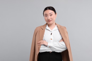 Photo of Portrait of beautiful businesswoman on grey background. Space for text