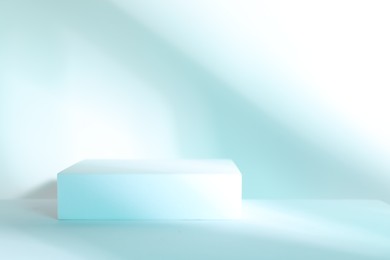 Photo of Presentation of product. Podium on light blue background, space for text