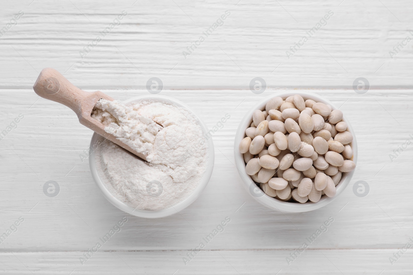 Kidney bean flour and seeds on white wooden table, flat lay Photo of Kidney bean flour and seeds on white wooden table, flat lay