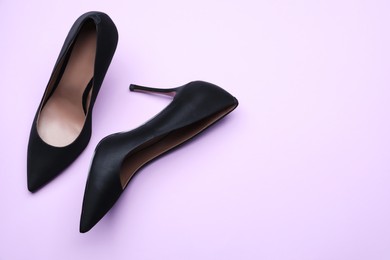 Photo of Pair of elegant black high heel shoes on light background, flat lay. Space for text