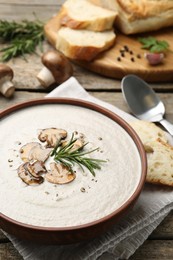Photo of Fresh homemade mushroom soup served on wooden table