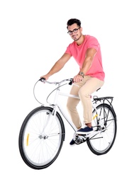 Photo of Handsome young hipster man riding bicycle on white background