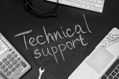 Photo of Flat lay composition with words "TECHNICAL SUPPORT" on dark background