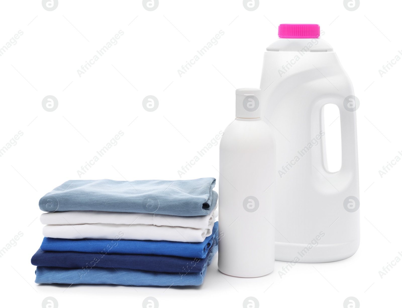 Photo of Stack of baby clothes and laundry detergents isolated on white