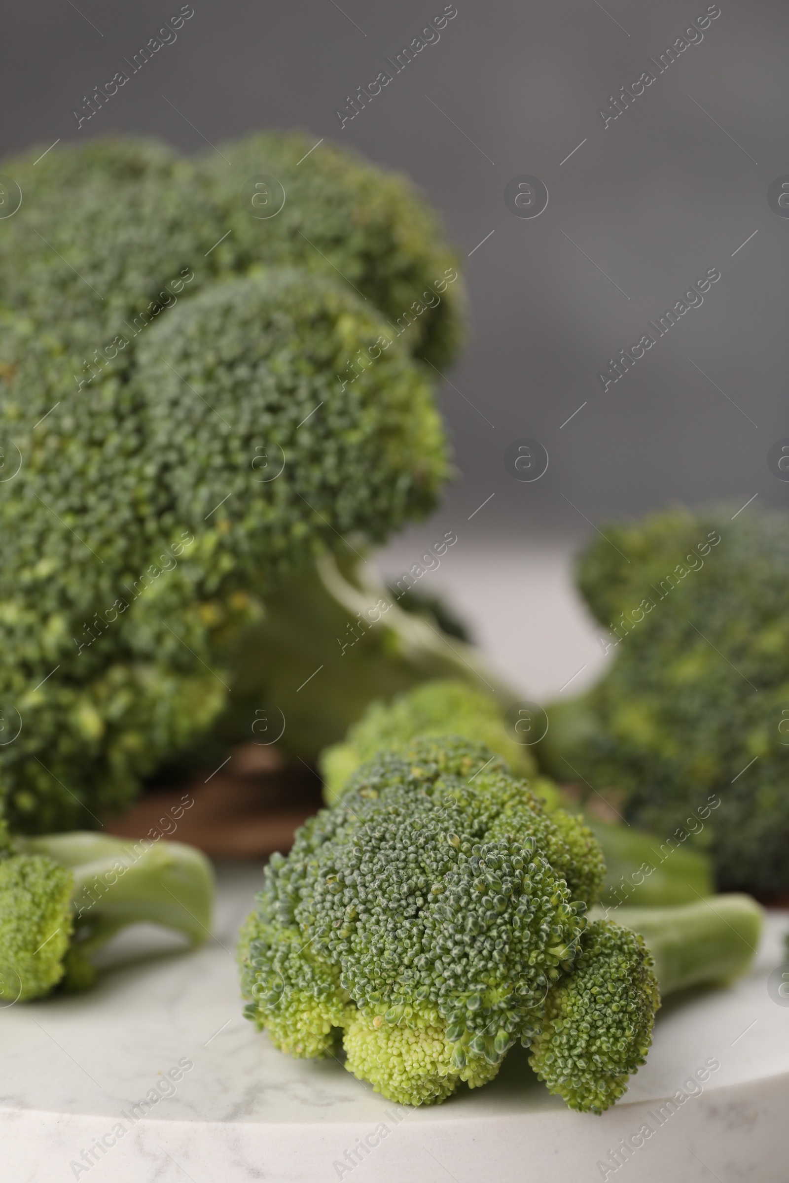 Photo of Tray with fresh raw broccoli on table, closeup