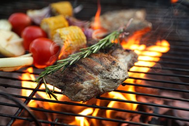 Photo of Cooking meat and vegetables on barbecue grill, closeup