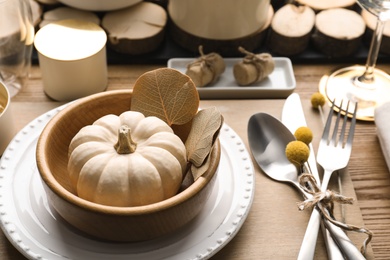 Photo of Autumn table setting with pumpkin and decor on wooden background