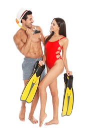Photo of Young attractive couple in beachwear with snorkel and flippers on white background