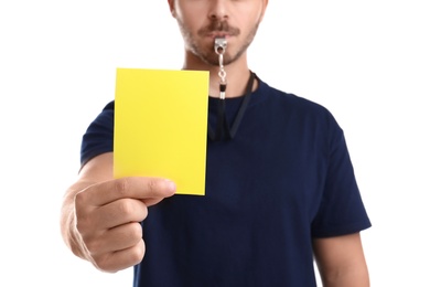 Photo of Football referee holding yellow card on white background, closeup