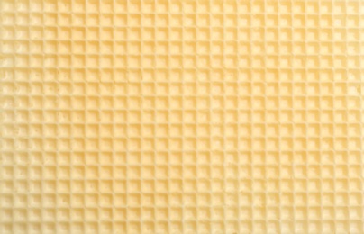 Photo of Tasty wafer as background, closeup. Crispy food