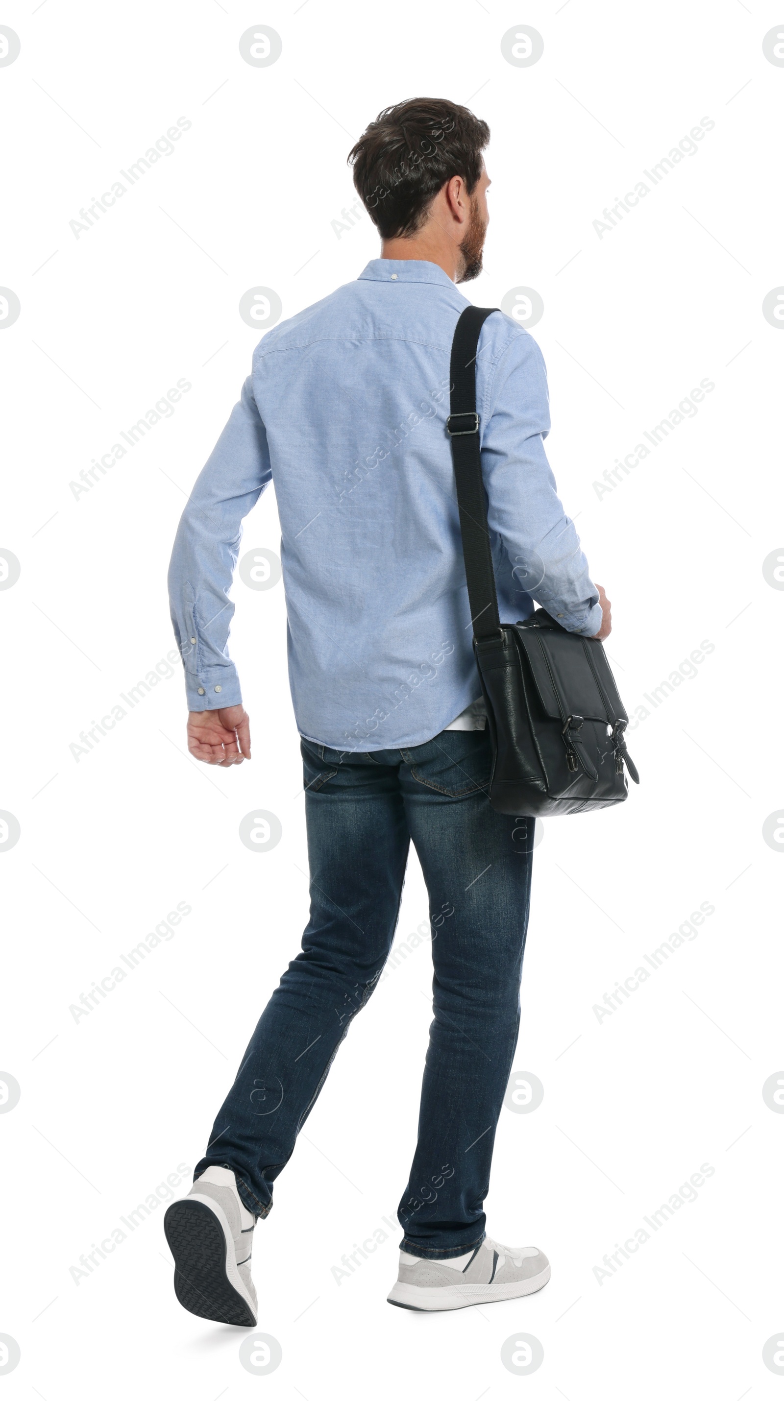 Photo of Man with bag in stylish outfit walking on white background, back view