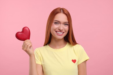 Photo of Beautiful happy woman with red heart on pink background