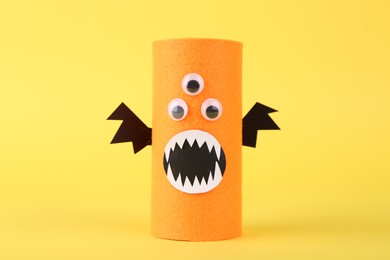 Photo of Spooky monster on yellow background. Handmade Halloween decoration