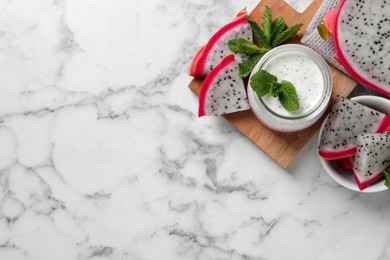 Photo of Tasty pitahaya smoothie, dragon fruits and fresh mint on white marble table, flat lay. Space for text