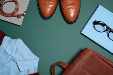 Photo of Stylish school uniform, glasses and notebook on green background, flat lay. Space for text