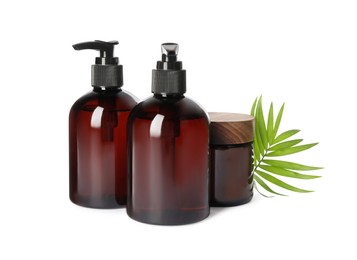 Photo of Bottles and jar of shampoo on white background