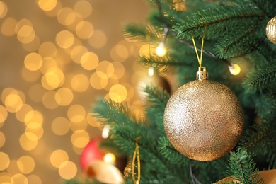 Photo of Beautiful Christmas tree with decor against blurred lights on background
