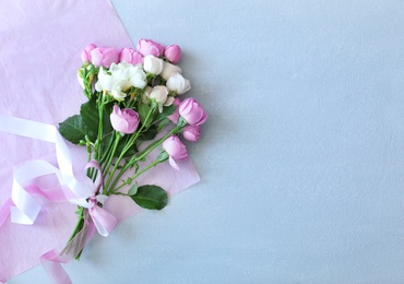 Photo of Bouquet of beautiful flowers on grey background, top view