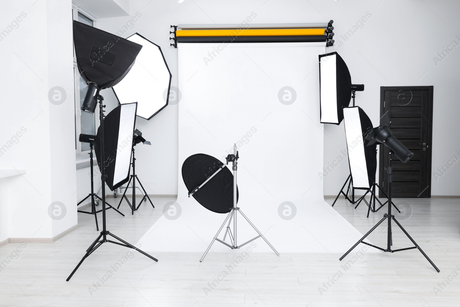 Photo of Interior of modern photo studio with professional lighting equipment