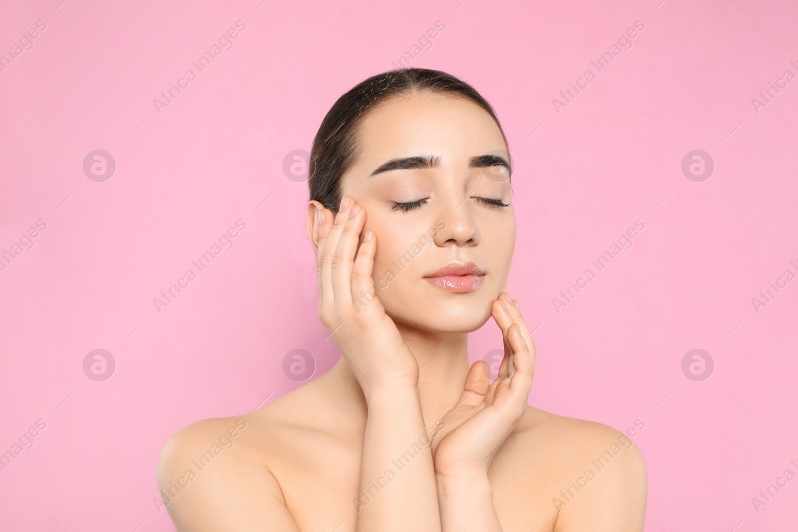 Photo of Portrait of young woman with beautiful face against color background