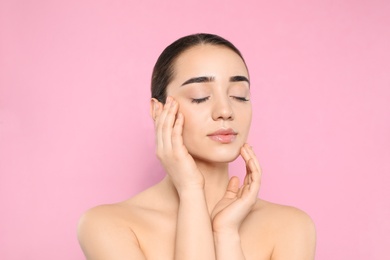 Photo of Portrait of young woman with beautiful face against color background