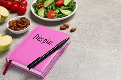 Photo of Weight loss concept. Notebook with pen and different products on grey table, space for text