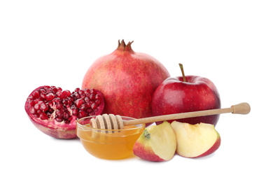 Photo of Honey, apples and pomegranate on white background. Rosh Hashanah holiday